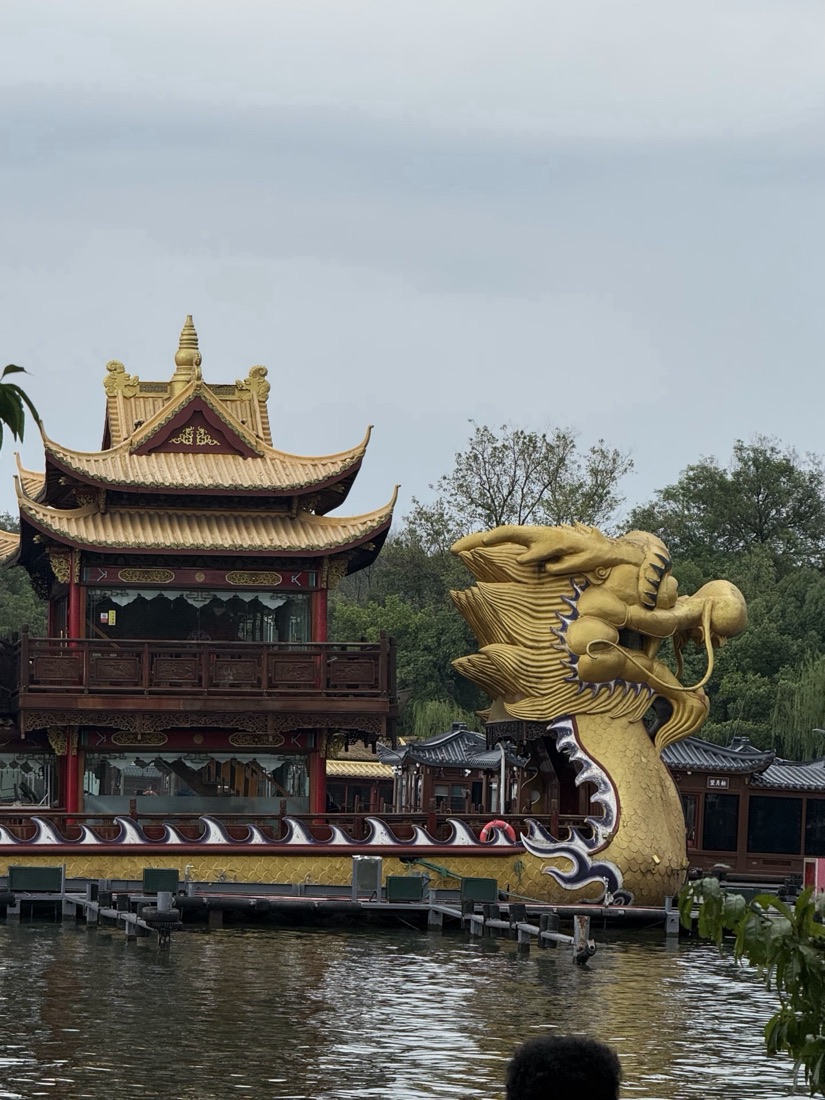 Golden dragon-prow boat on West Lake